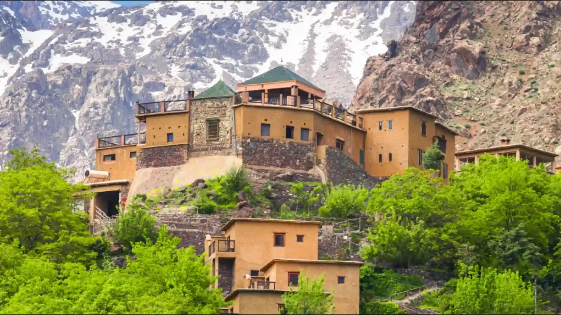 2 days tour from Marrakech to Zagora 3 Berber village architecture in Morocco’s Atlas Mountains blending with landscape, featured on a 2 days tour from Marrakech to Zagora.