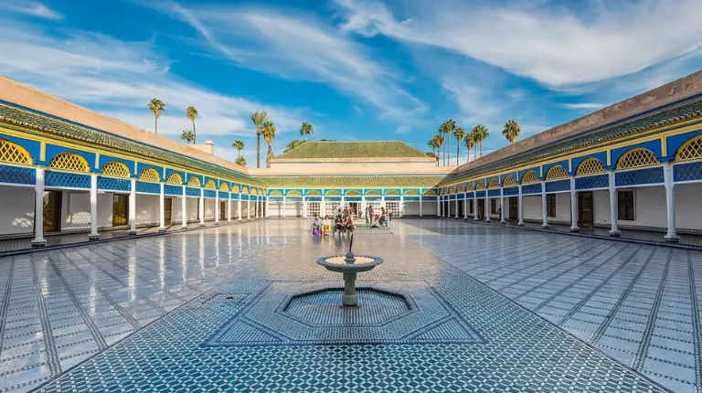 Grand courtyard features ornate arches, intricate tilework, and tranquil symmetry reflecting refined Moroccan palace design on a Marrakech Itinerary 4 Days.