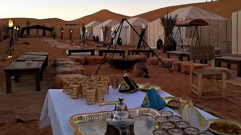 Luxury desert camp near Merzouga offers glamping experience with elegant tents, modern comforts, and sweeping Sahara dune surroundings views.