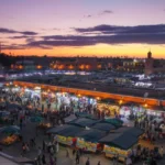The bustling Jemaa el-Fnaa square in Marrakech comes alive at dusk, showcasing vibrant activity and culture with moroccotripway.