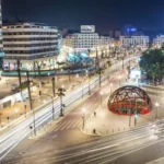 Casablanca boulevard at night with dome sculpture