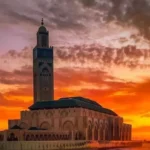 Hassan II Mosque silhouette at fiery sunset